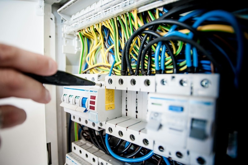 iemand die met een schroevendraaien werkt aan de meterkast